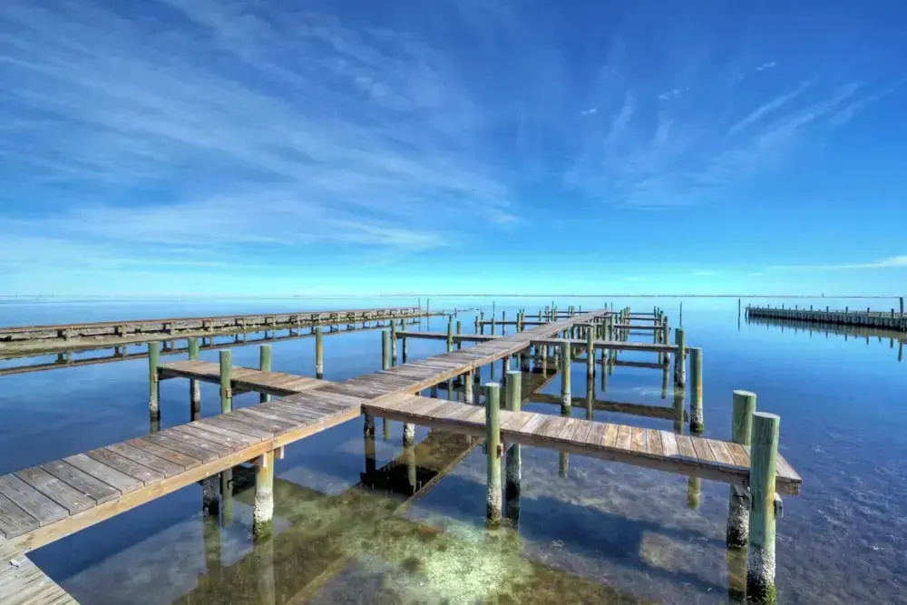 Balcony w/ Bay View Shared Pool + Boat Dock Fat Flounder by Avantstay