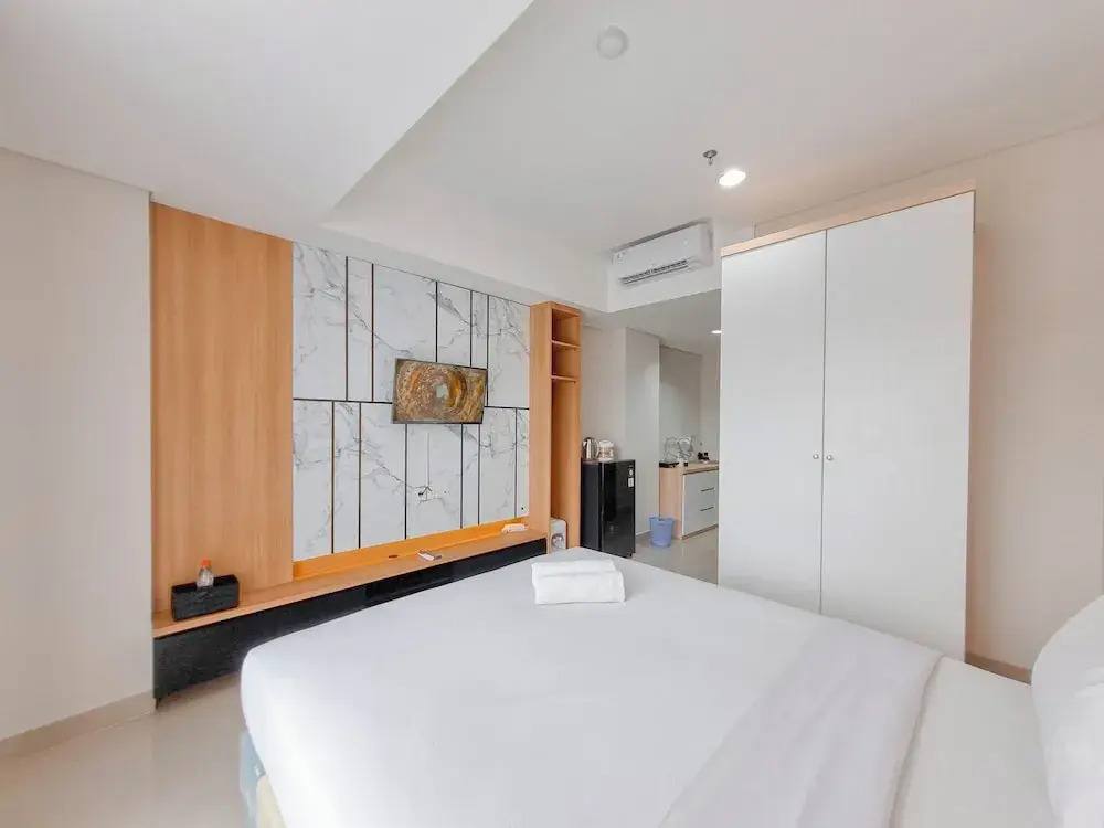 Homey Studio at Patraland Amarta Apartment By Travelio