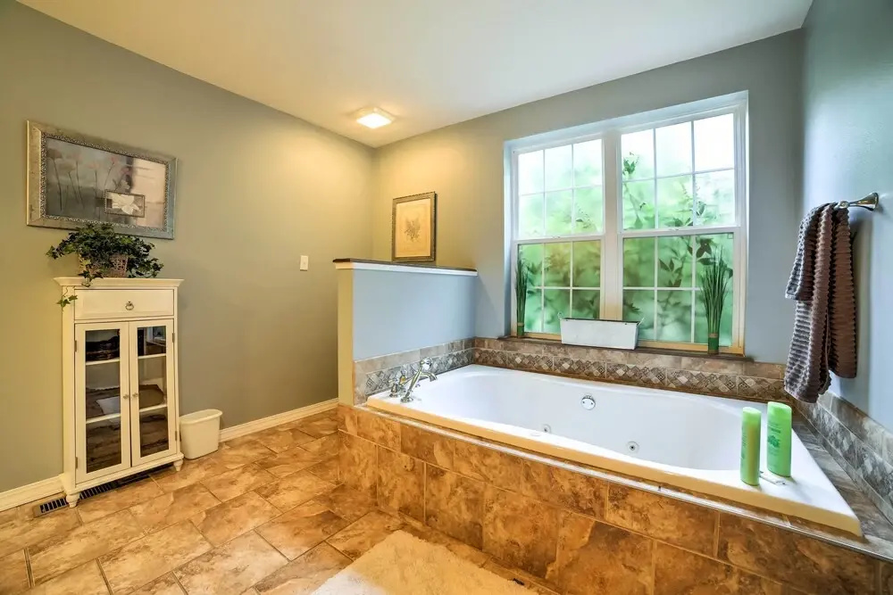 Hot Tub & Wooded Views: Lakefront Blue Eye Cottage