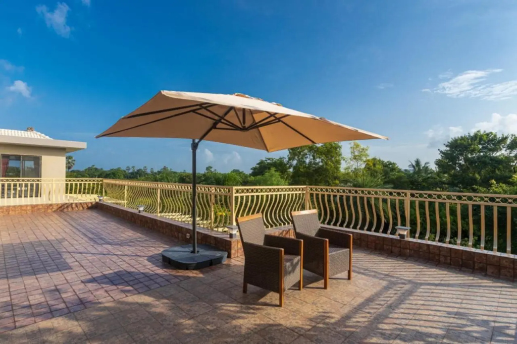 SaffronStays Aura - 4BR luxury pool villa with gym, BBQ deck, lawns & indoor games near Kihim Beach