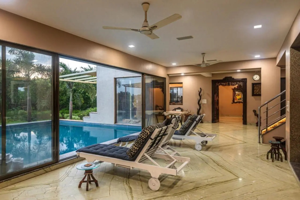 SaffronStays Aura - 4BR luxury pool villa with gym, BBQ deck, lawns & indoor games near Kihim Beach