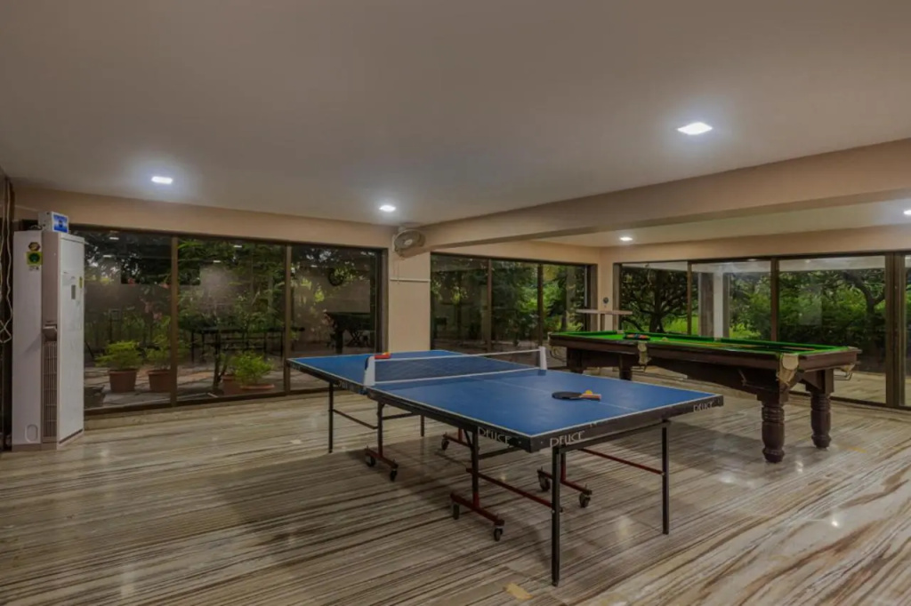 SaffronStays Aura - 4BR luxury pool villa with gym, BBQ deck, lawns & indoor games near Kihim Beach
