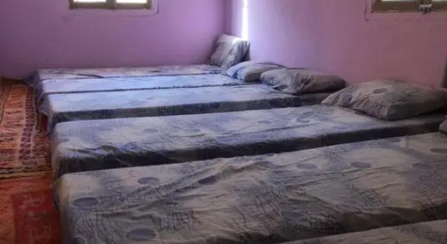 Кровать в общем номере Gite La belle vue Timichi